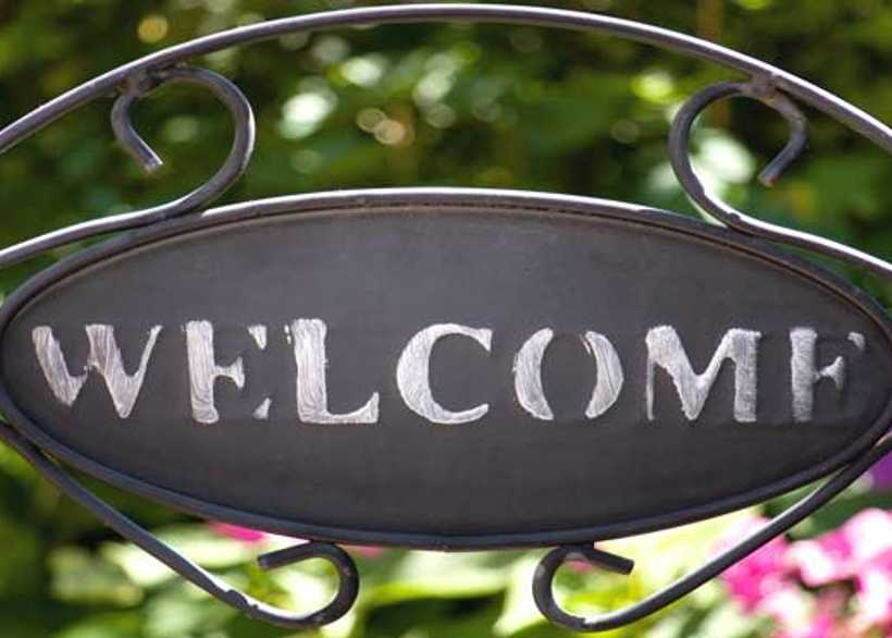 Welcome sign on gate to garden backdrop